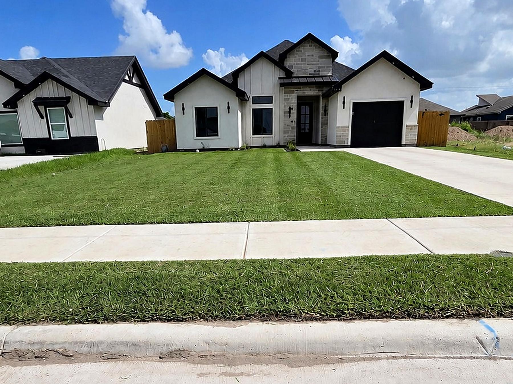 Striped front lawn at a modern farmhouse home