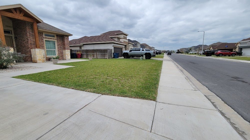Brick home with freshly edged front lawn and clean sidewalk lines